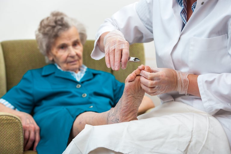 Grandma Getting Her Nails Done By A Doctor
